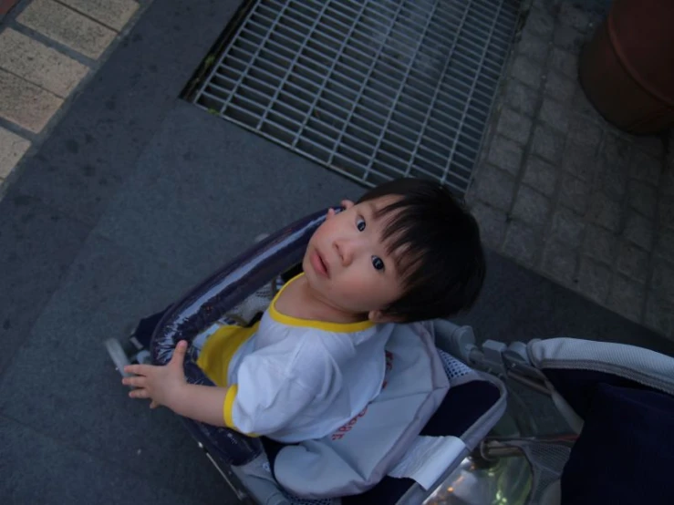 a little boy laying inside a suitcase and looking up at soing
