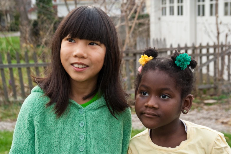 two little girls are looking into the camera