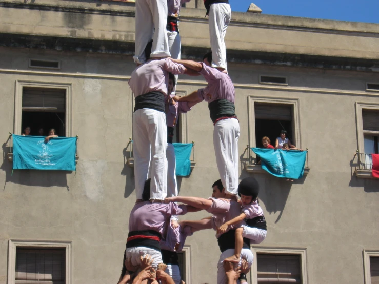 a group of people stand on top of a sculpture