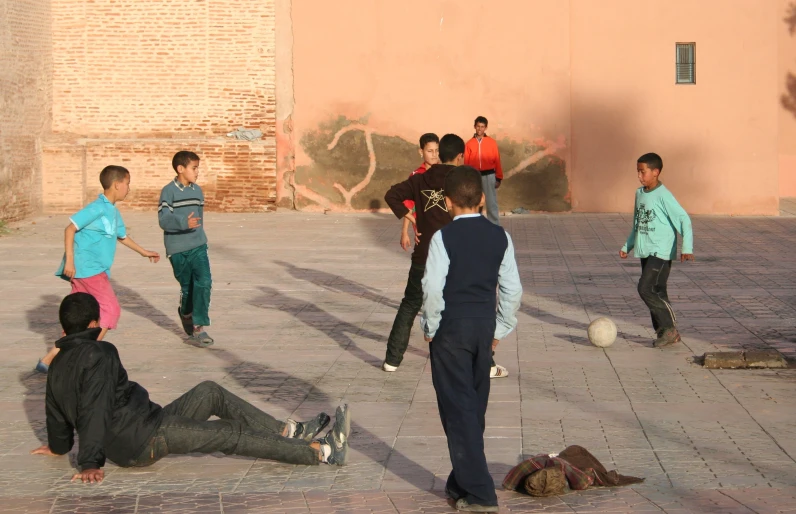 the children are playing soccer together outside