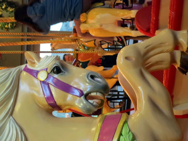 a colorful pony is on a carousel at a carnival