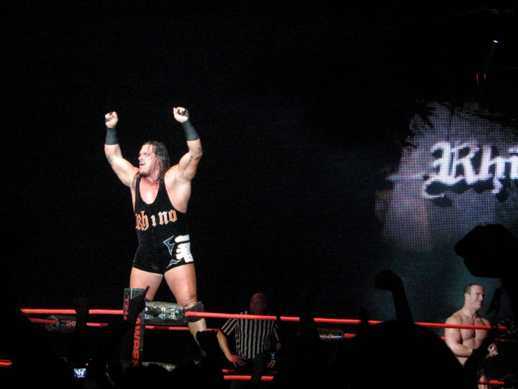 a man in black wrestler outfit on a boxing ring