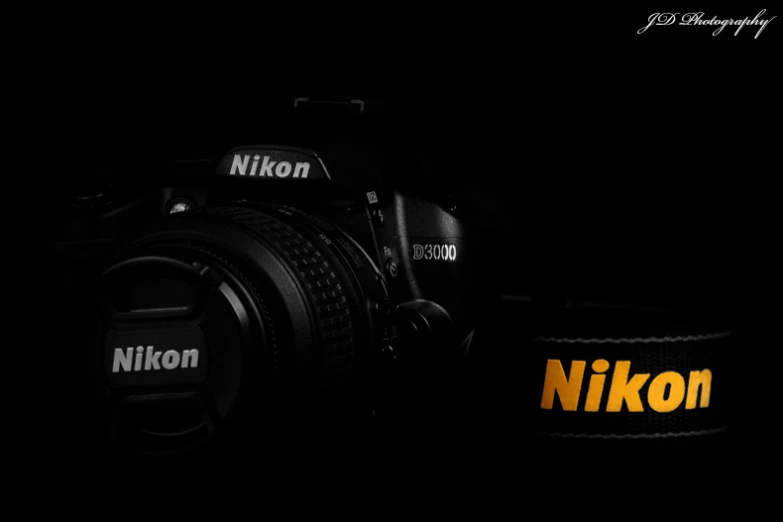 nikon camera with a black background and a yellow logo