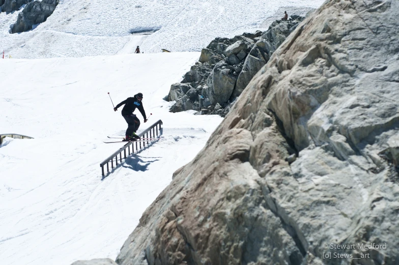 a person on skis that is coming down the snow