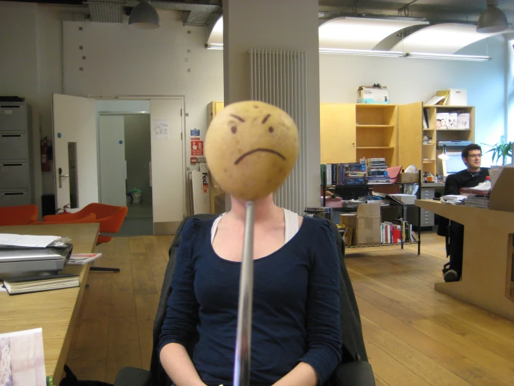 a lady has a frowning face on her head