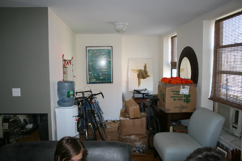 this living room has several boxes and bicycles in it