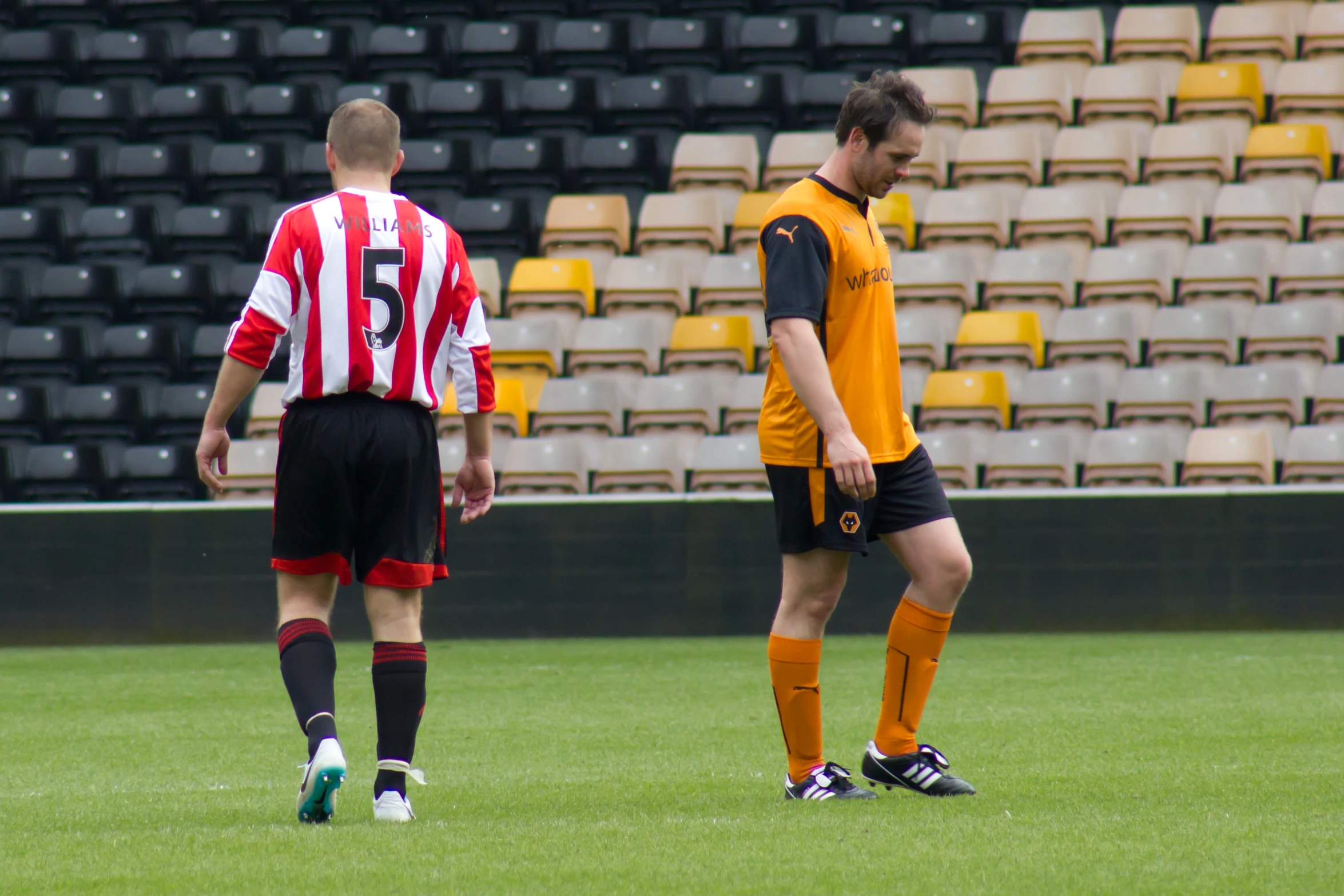 two young men standing around during a soccer game