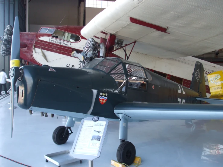 a fighter plane sitting on top of a museum floor