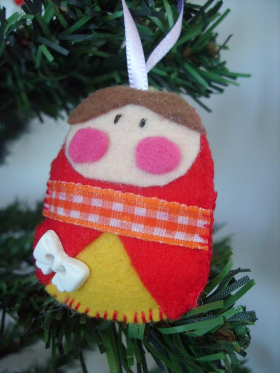 an ornament hanging from a tree with decorations