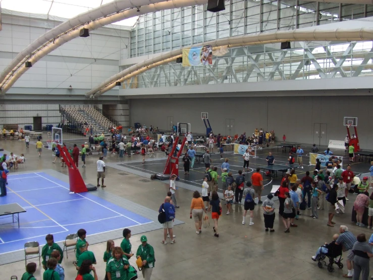an indoor basketball court filled with people