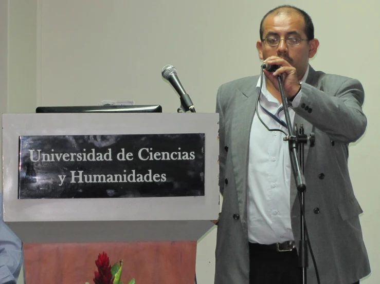 a man giving a speech on stage at an event