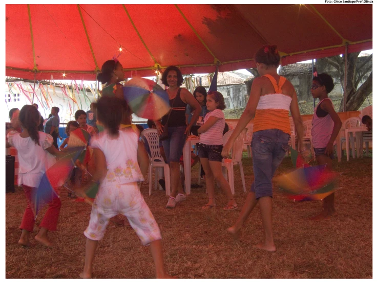 some s are playing with colors in an tent