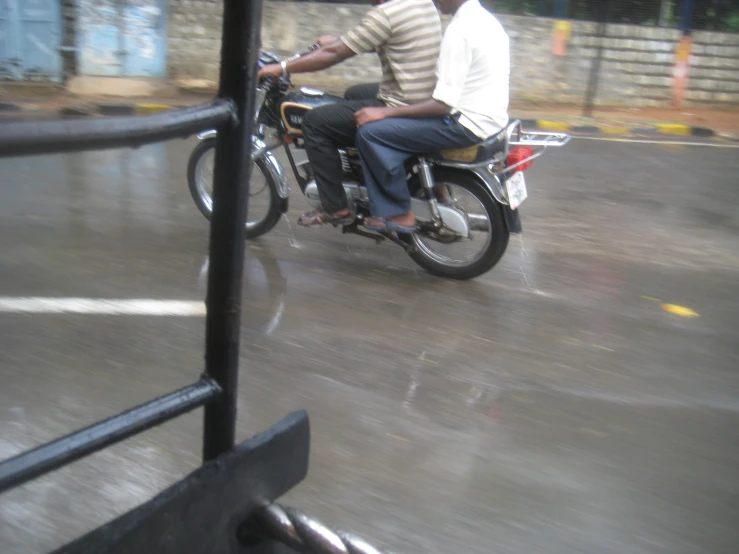 the two people are riding together on the bike