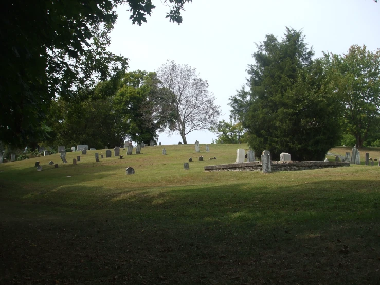 a cemetery with a lot of graves in the grass