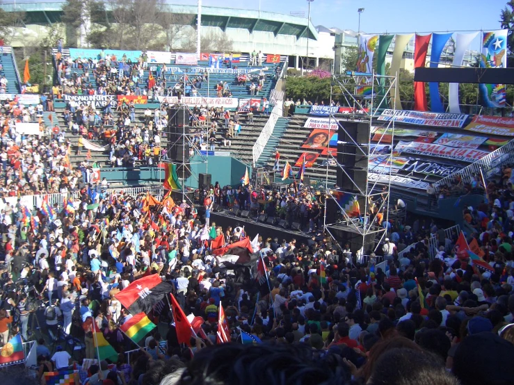 a crowded stadium with people sitting and walking