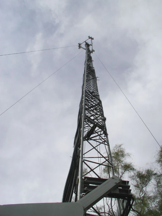 an old, metal structure with an electrical antenna near the top