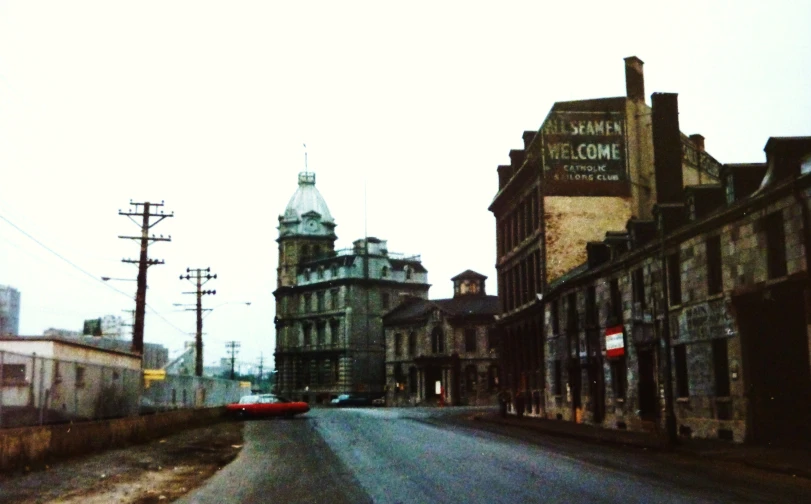 an old po of some buildings on the street