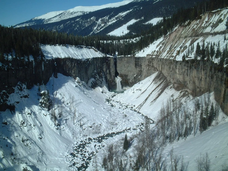 the snow on the ground is covering the cliffs