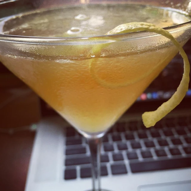 a close up of a drink in a glass on a laptop