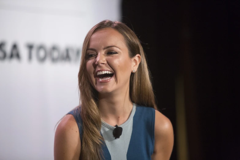 an image of a woman talking on stage