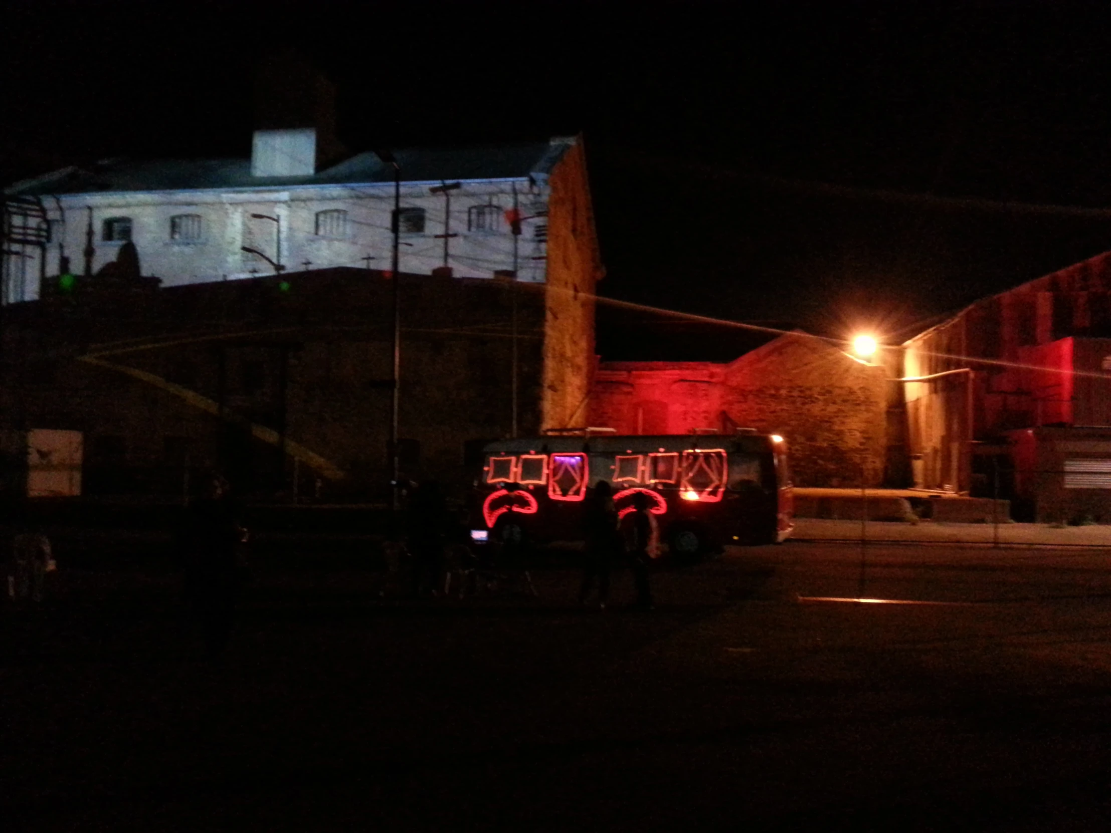 a truck parked on the side of the street in the dark