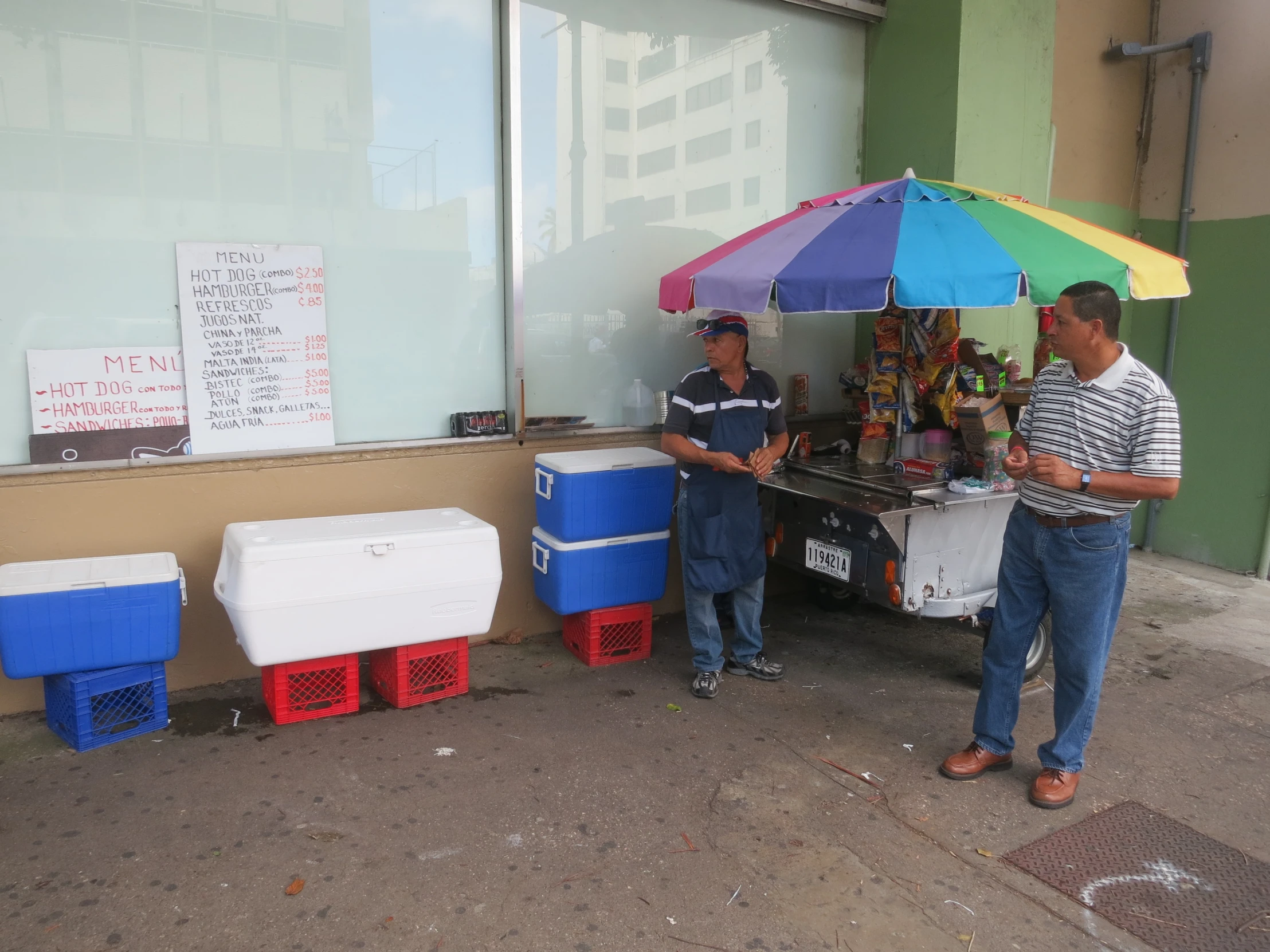 a man stands by a cart selling drink