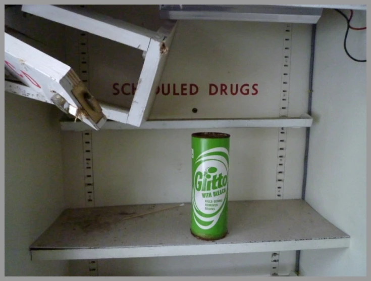 a green and white bottle of corona on a metal shelf