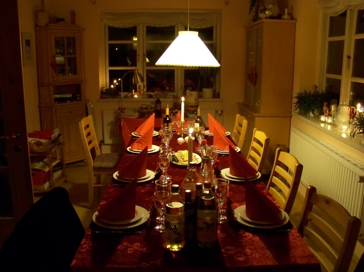 a dining table with a lighted candle on it