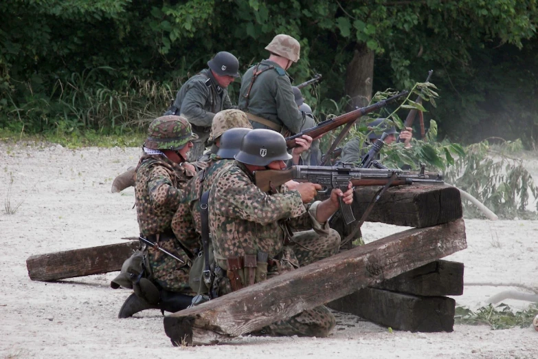 several soldiers are looking through the guns of another soldier