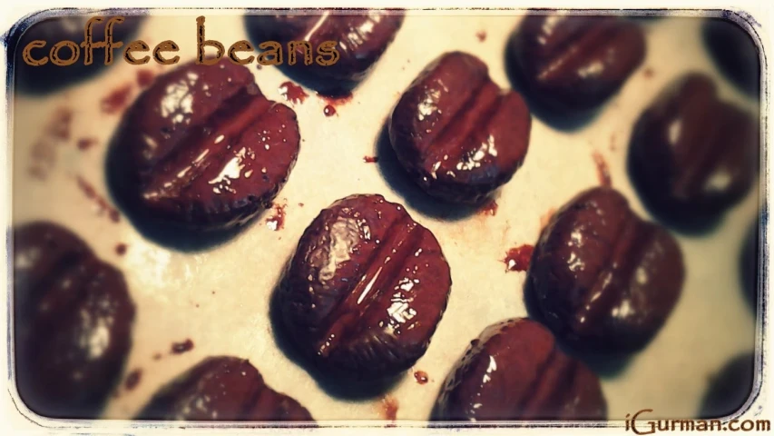 some chocolate beans sitting on top of a white tray