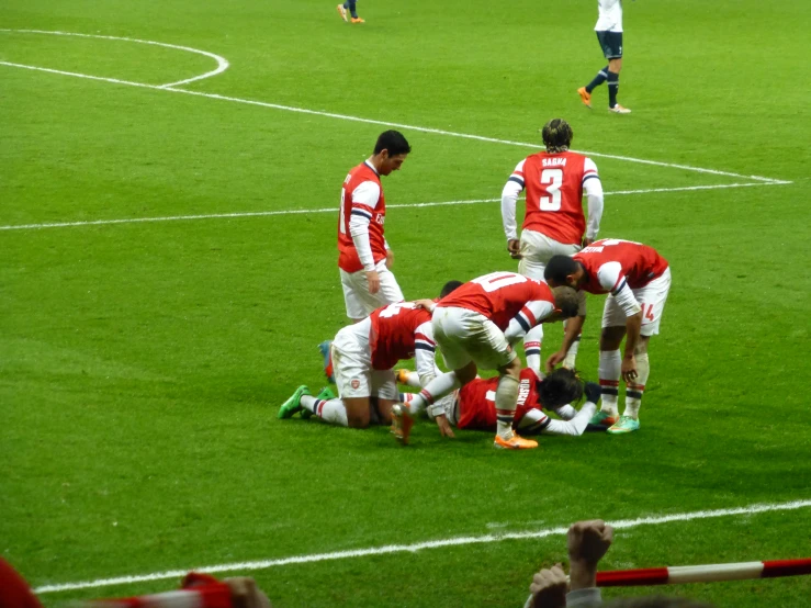 the men are huddled in the middle of the pitch