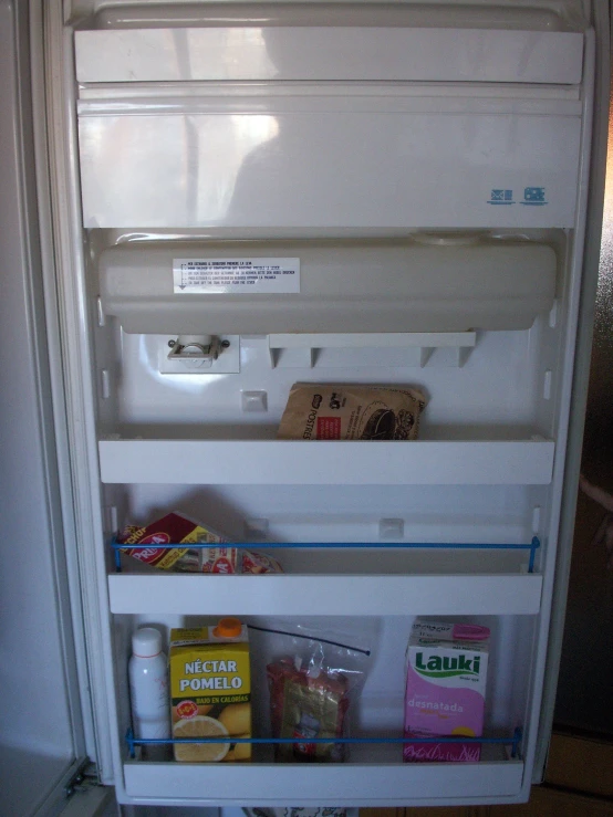 a refrigerator has food inside and is on display