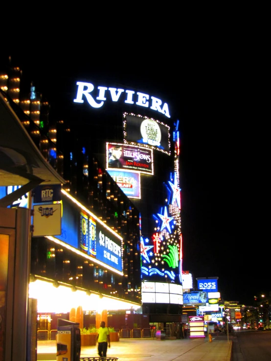 a man walking down a street at night