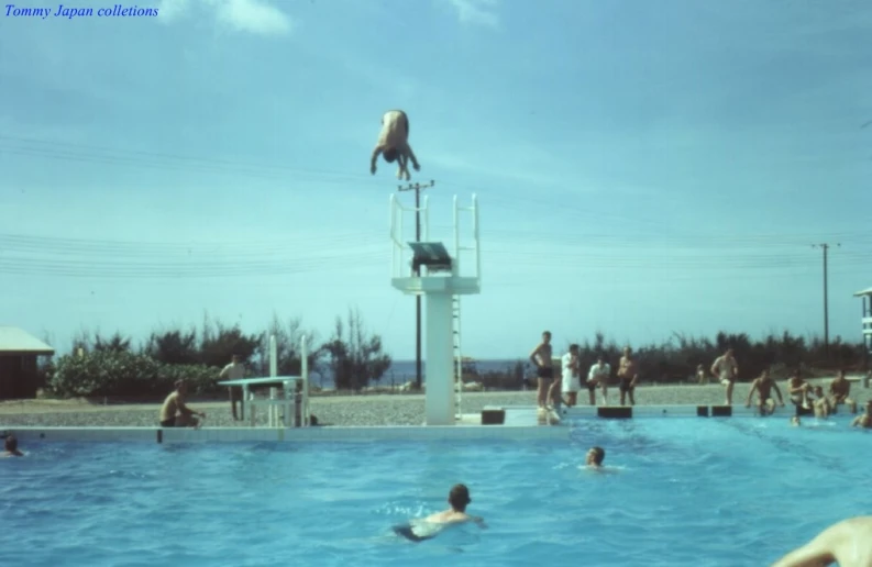 the people are playing volleyball in the pool