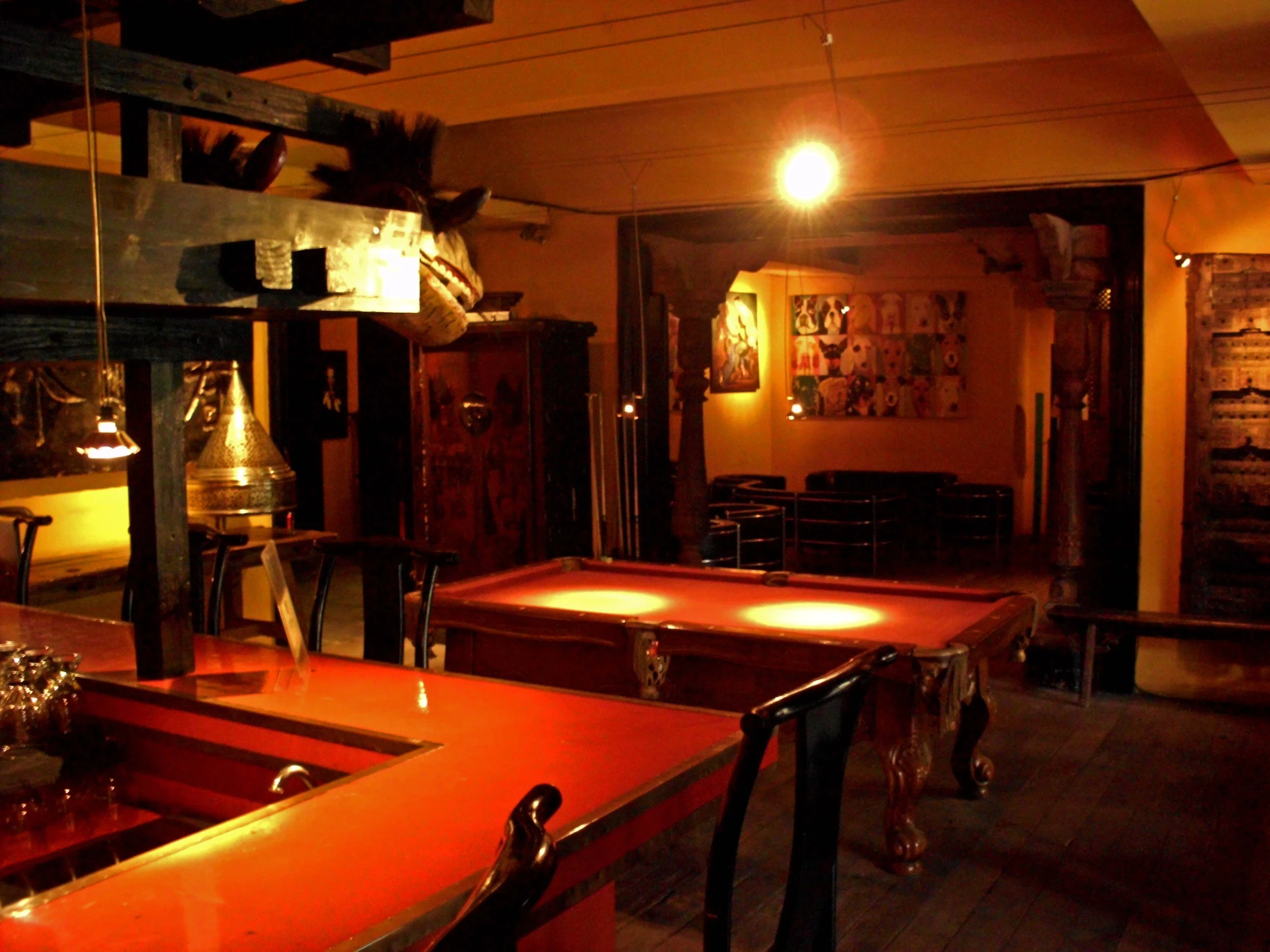 a very dimly lit restaurant with red tables