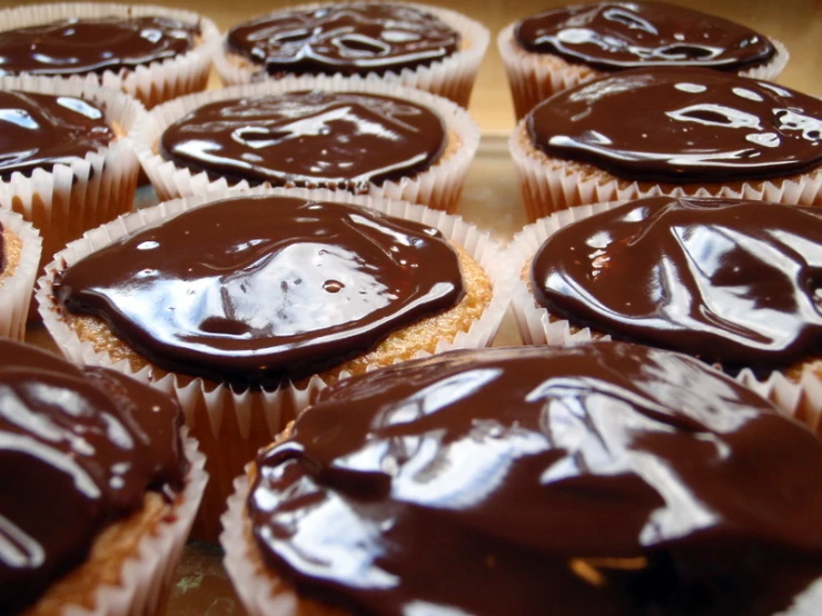 cupcakes with chocolate frosting with a smiley face on the top