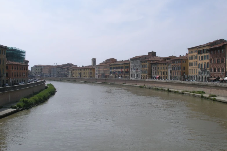 there are several buildings along the river in the city