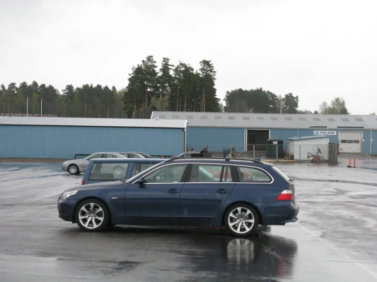 a blue car parked in front of an office building