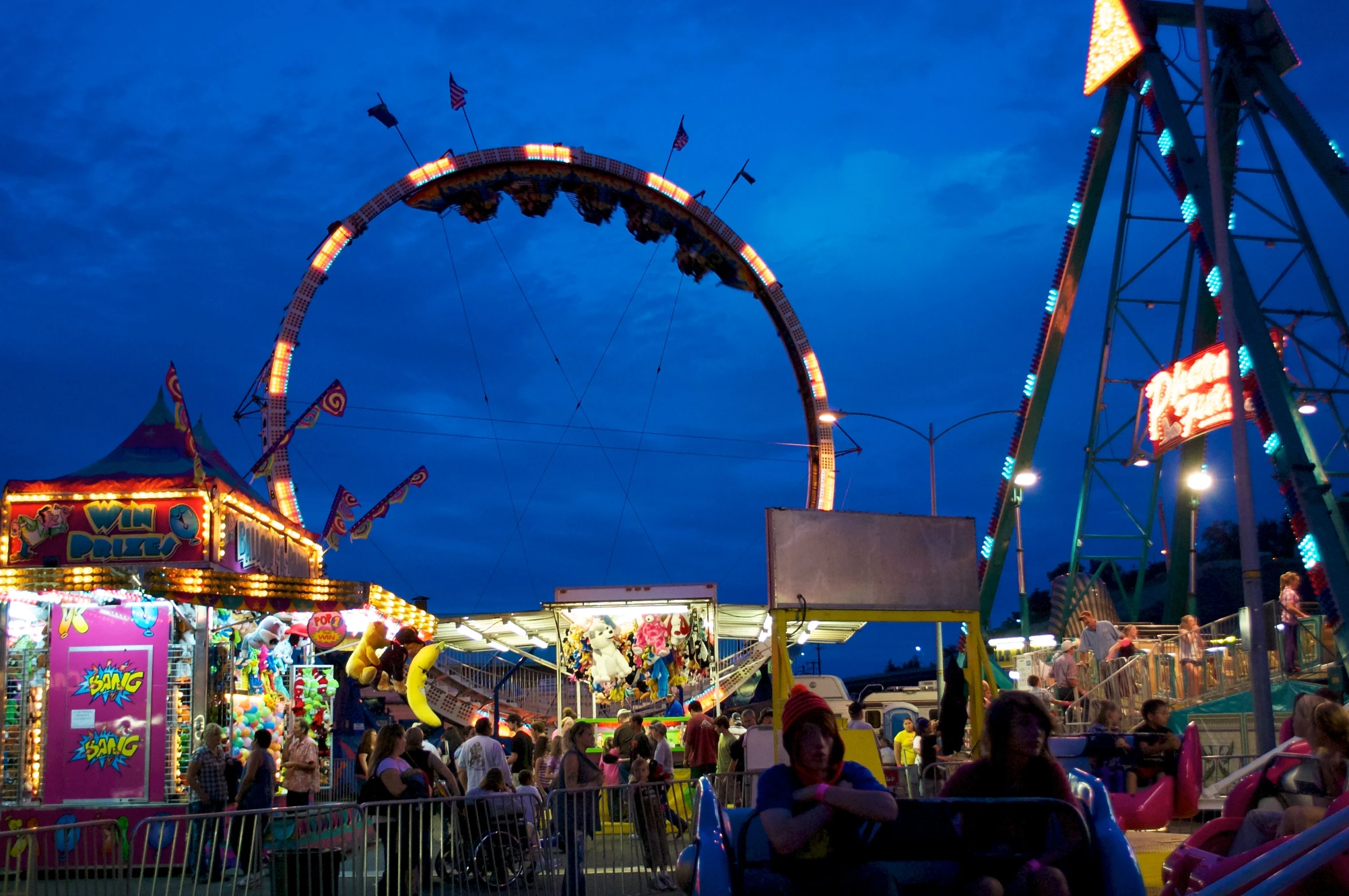 an amut park with rides lit up for the night