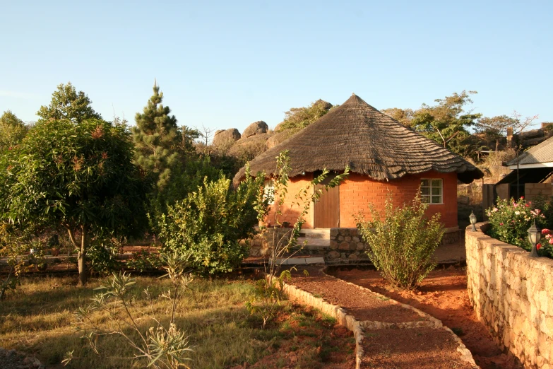 this is an outdoor area with a little cottage and trees