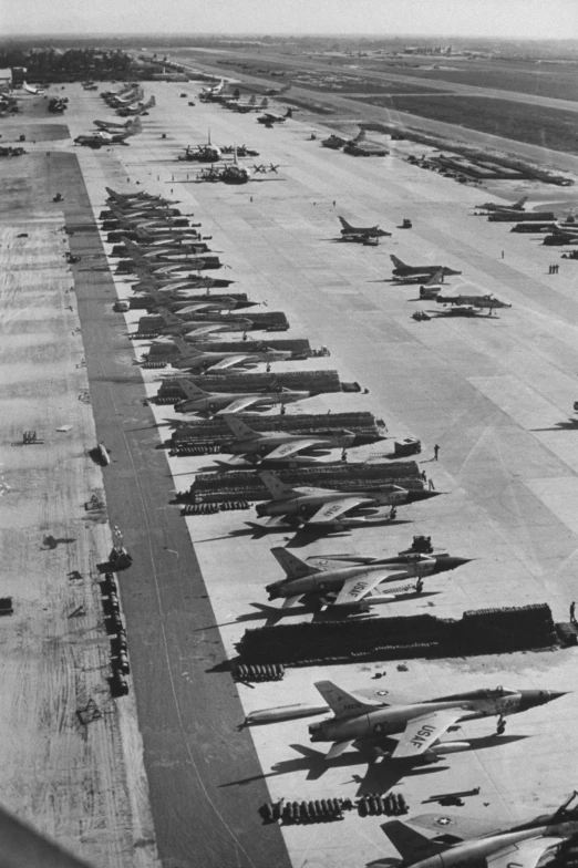 a row of planes parked on an airport tarmac