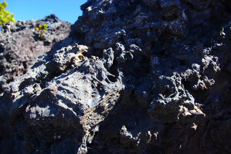 rocks and lava cover the landscape at the edge of the ocean