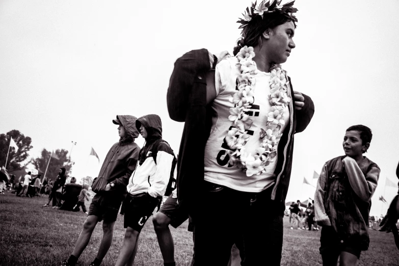 several people stand in a field with the wind blowing their hair