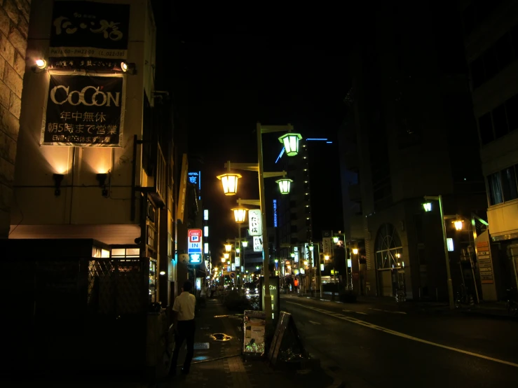 an empty street with the city lit up at night