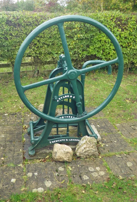 a large metal wheel that is on the ground