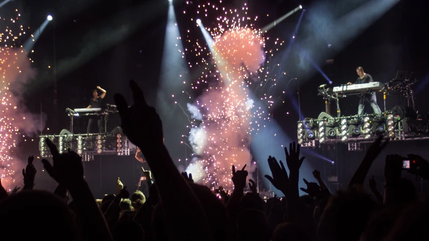 the stage is set for a huge concert as fireworks are lit