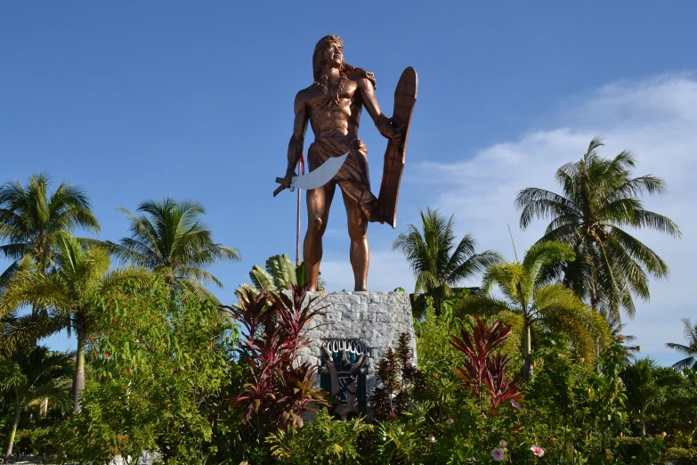 statue of man holding a surfboard over his body