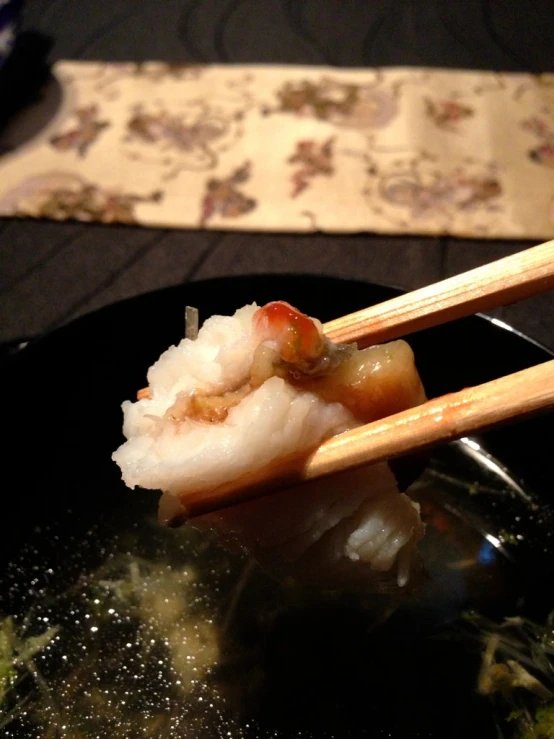 there is shrimp with chopsticks on top of the bowl