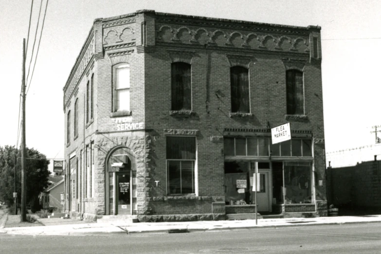 the old brick building has boarded doors