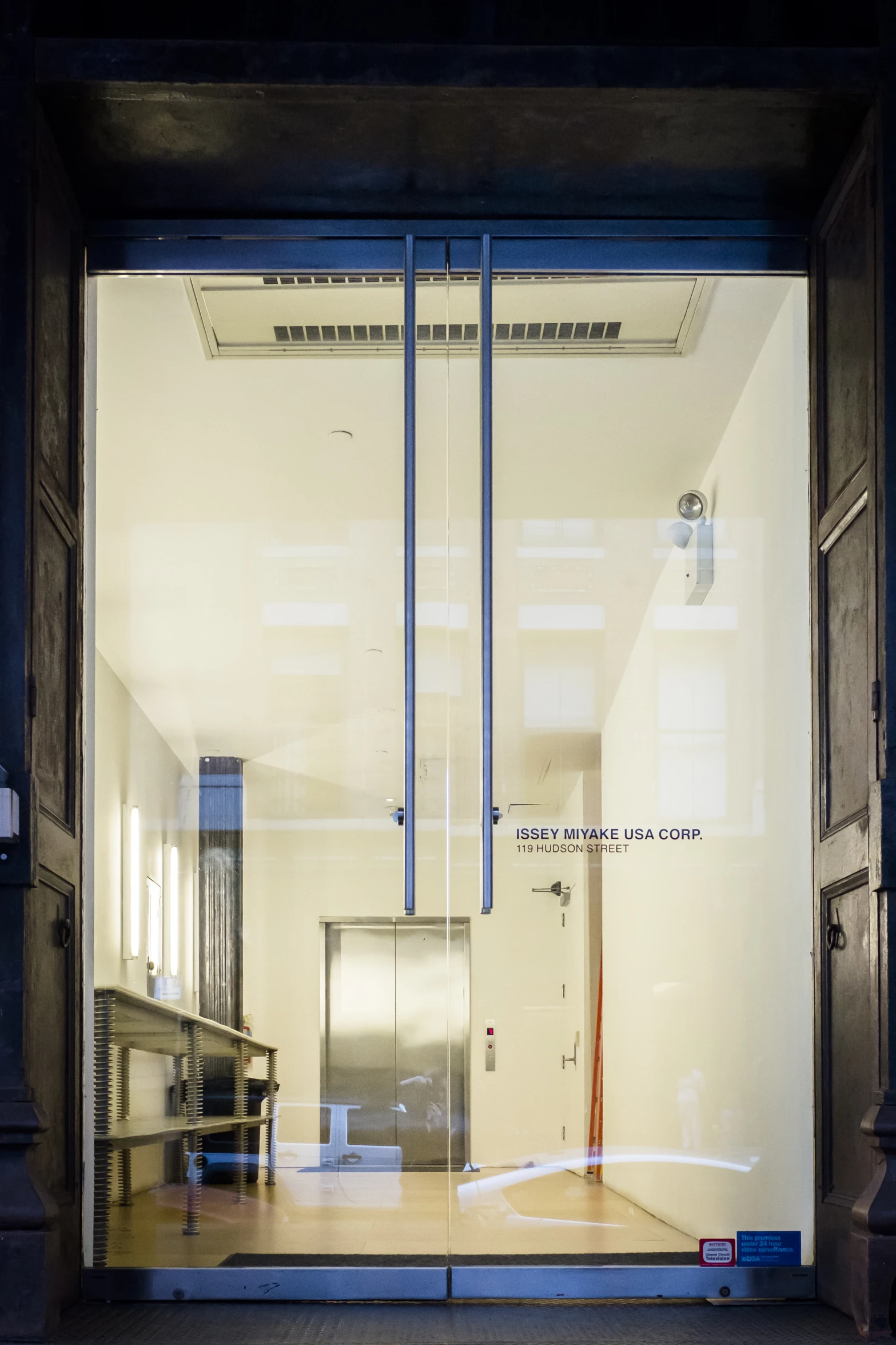 a door with some glass on top in front of a building